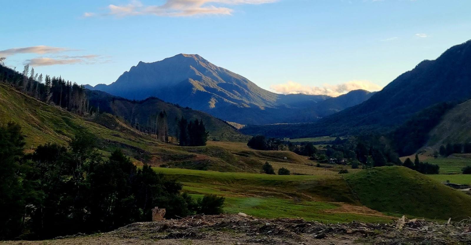 Farmland, river and mountains in the Glenroy Valley at sunset
