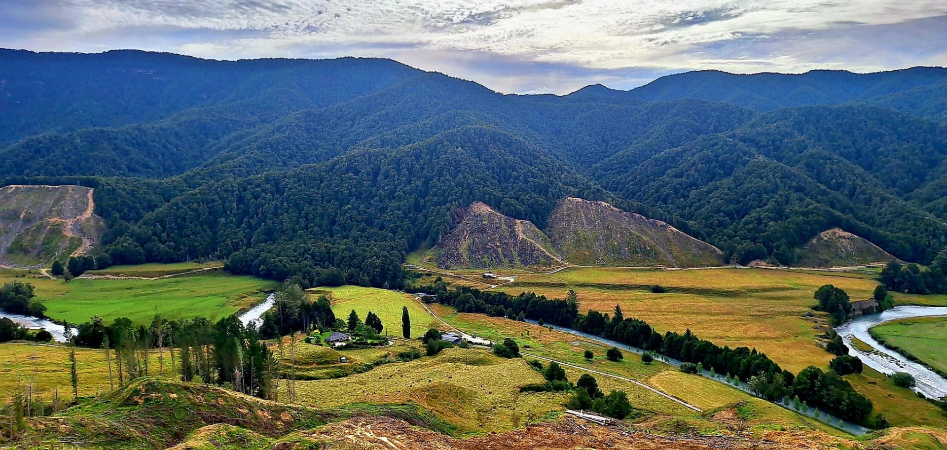 The Glenroy Valley farm, river and forested hills from above